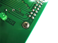 See the screw that secures the edge socket to the PCB. The original Atari board lacked this hardware.